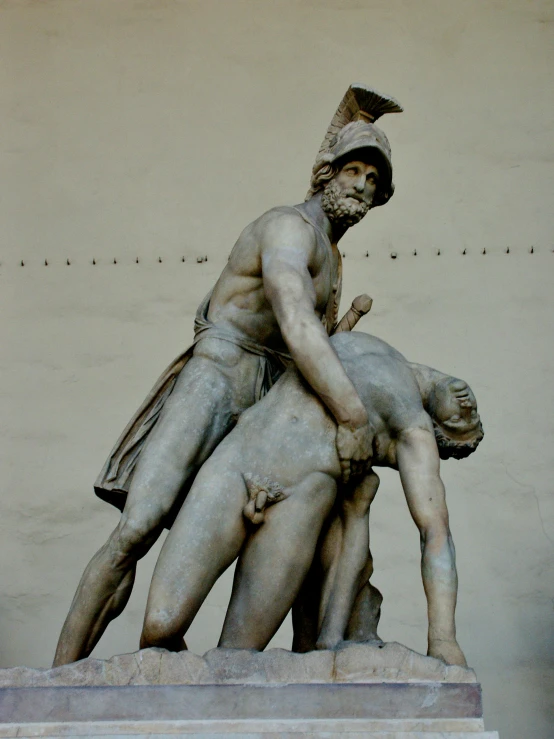 there is a statue depicting two men standing over each other