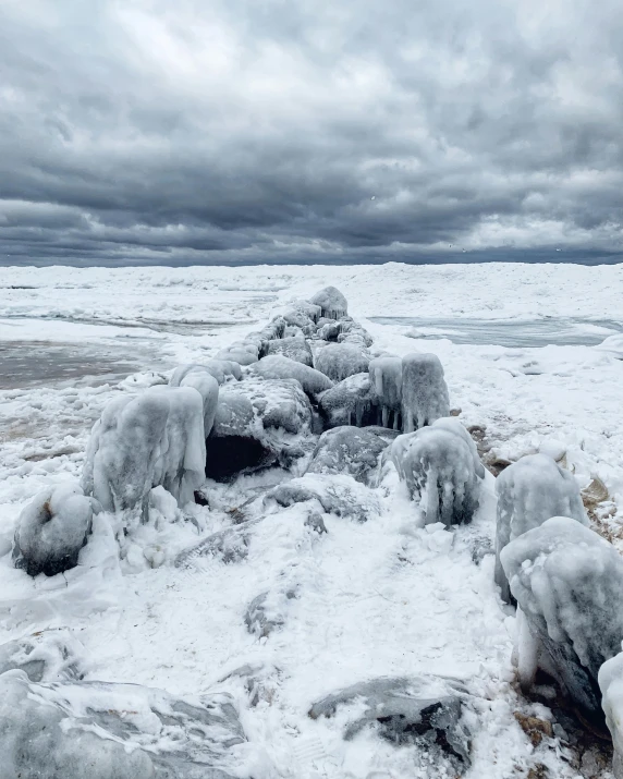 a beach has snow piled on it and is covered with ice