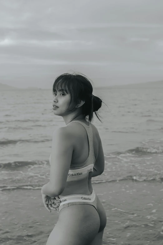 an asian girl wearing a bikini on the beach