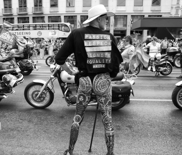 the man in the white hat is sitting on a motorcycle with several people riding behind him