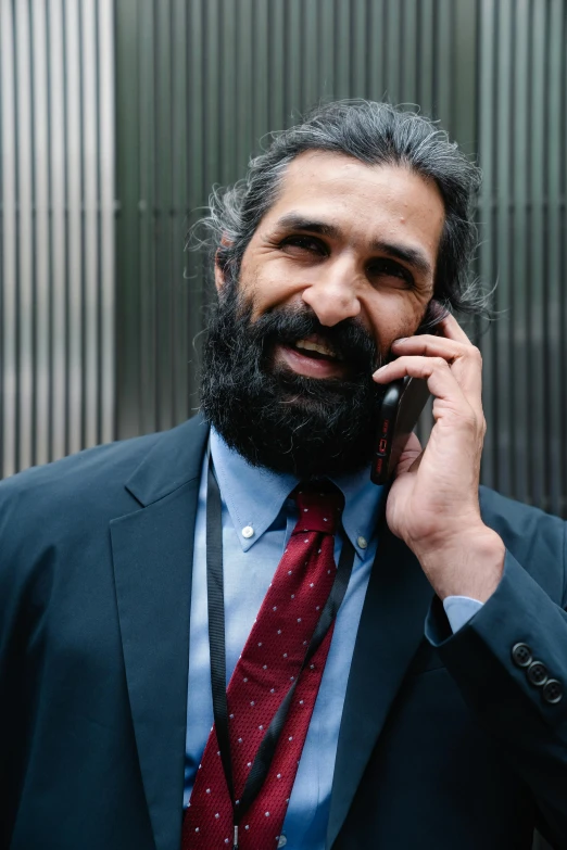 a close - up of a person with a suit and tie on a phone