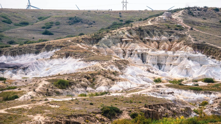 an old quarry with snow on it in the mountains