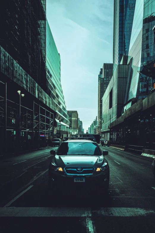 a car is driving down the road of a city