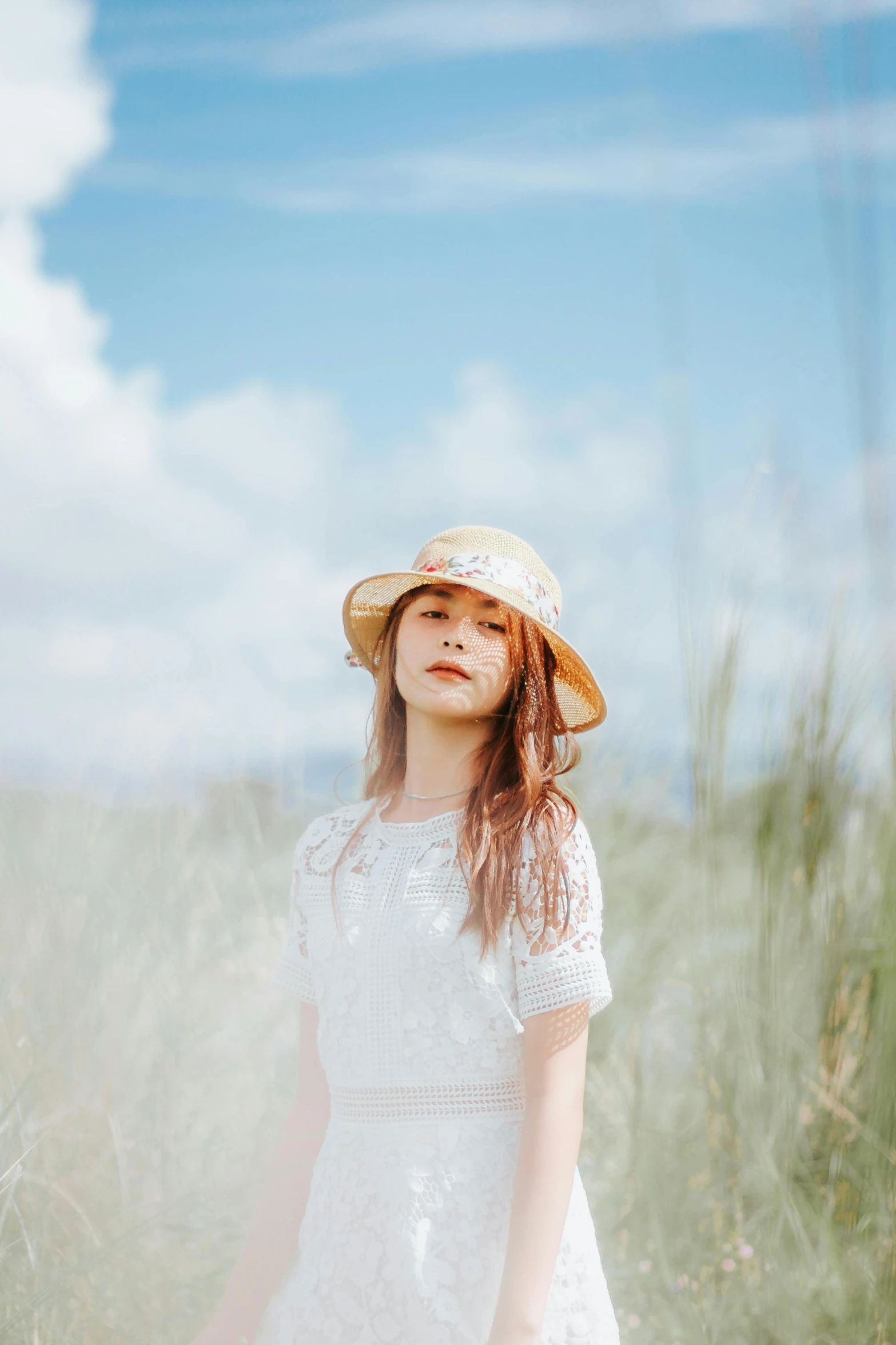 a  wearing a white dress, hat and bag