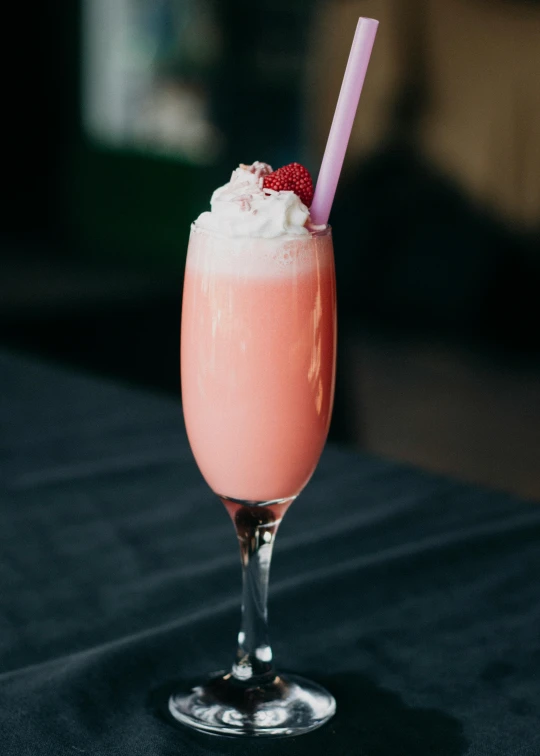 pink drink with ice cream on black table