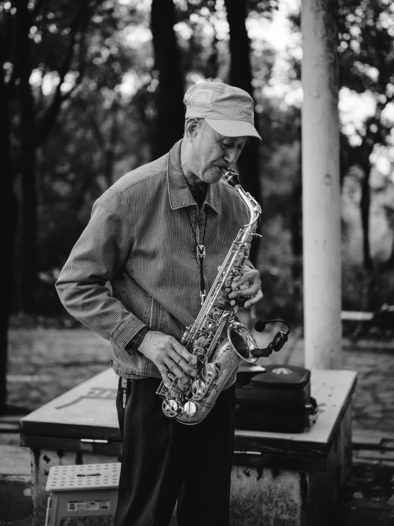 a black and white po of a person playing saxophone