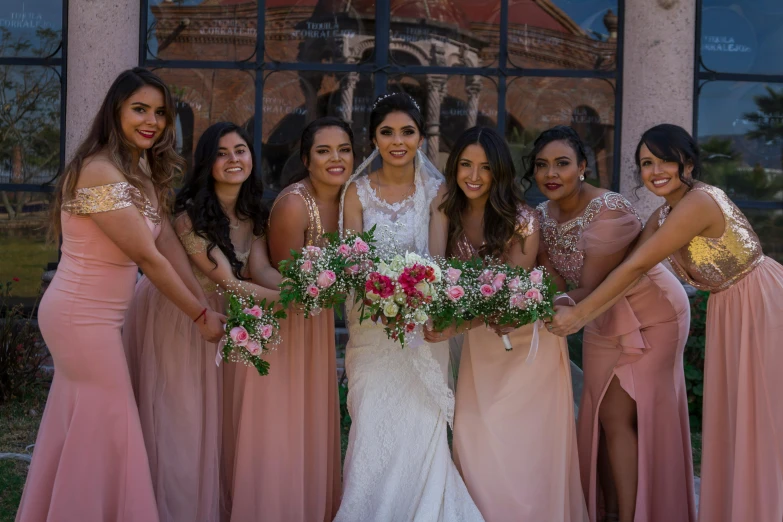 several beautiful women standing in front of a building