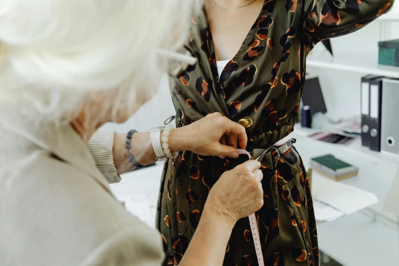 the woman is sewing an animal print shirt