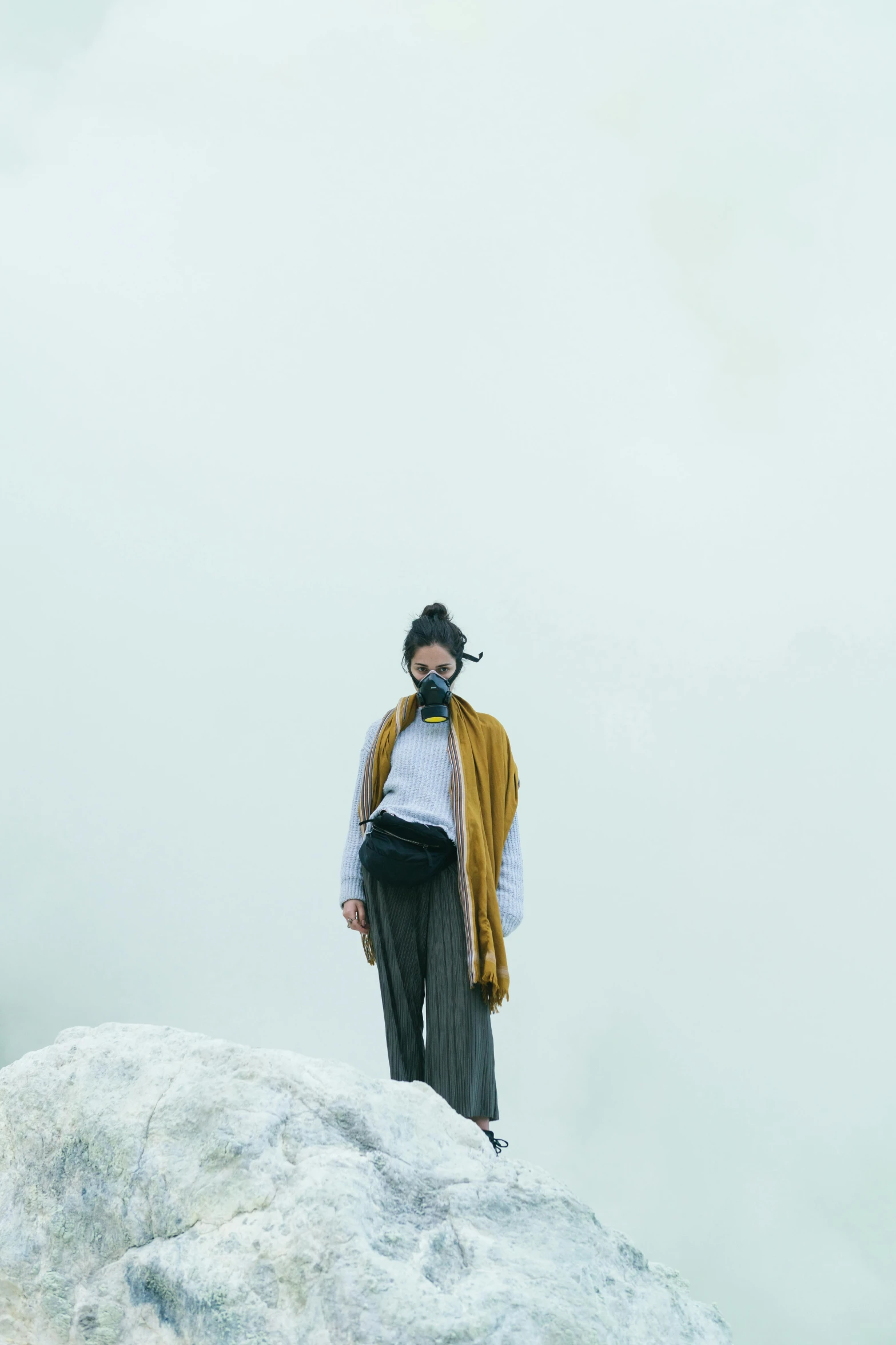 a woman standing on top of a snow covered slope