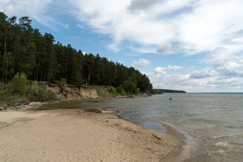 an empty beach with boats on the shore