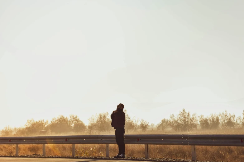 man on the side of the road taking a pograph of himself