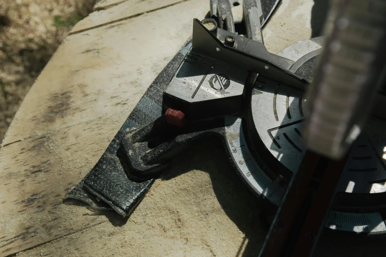 there is a metal object on the cement next to a broken umbrella