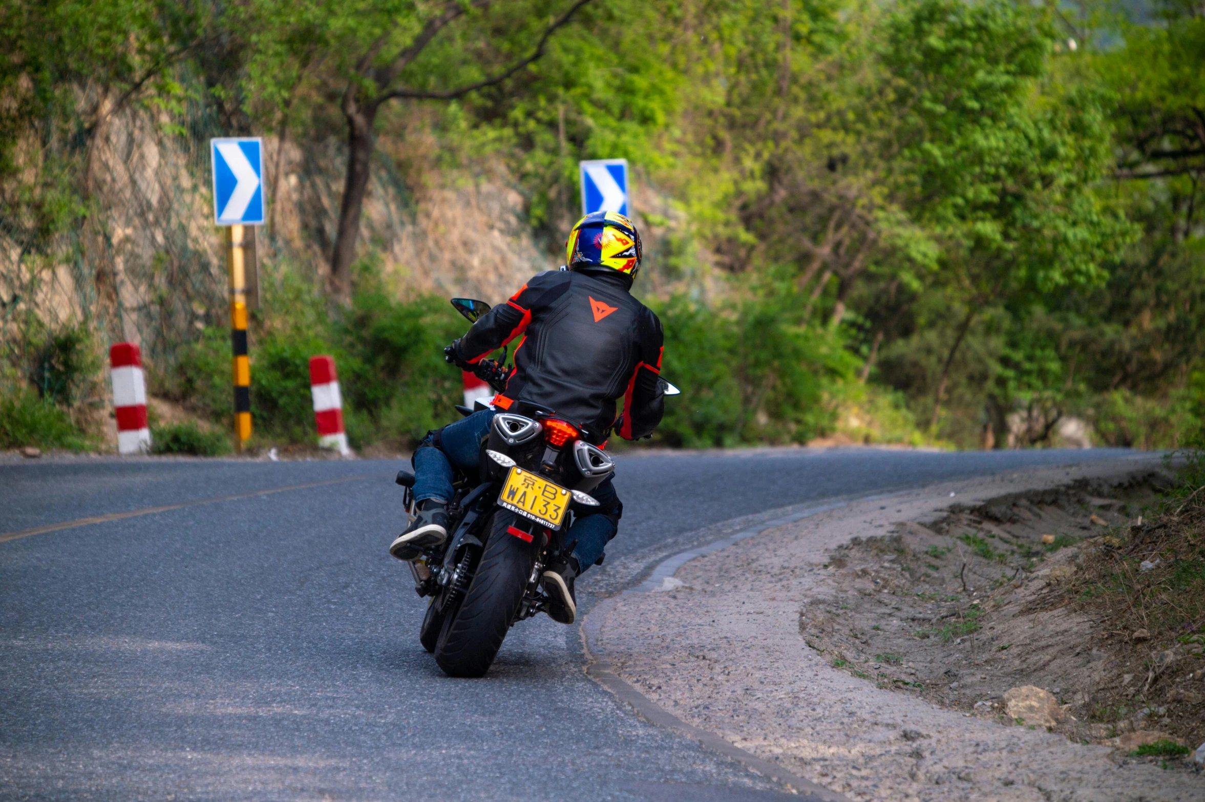 the rider is riding his motorcycle down the road