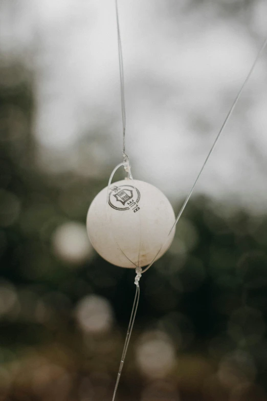 a white ball hanging from a wire