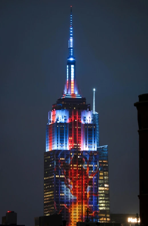 a very tall building with a colorful light up tower