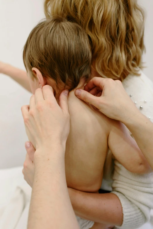 two people standing and hugging their heads to one another