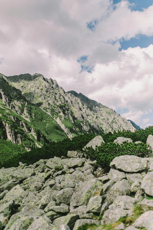 there is rocks piled on the ground at the top of the mountains