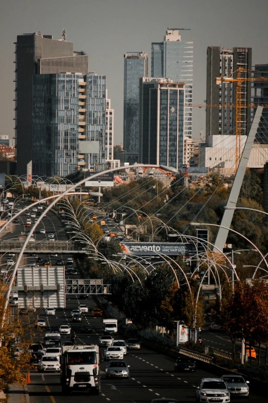 several cars are traveling on the freeway, passing through the large city