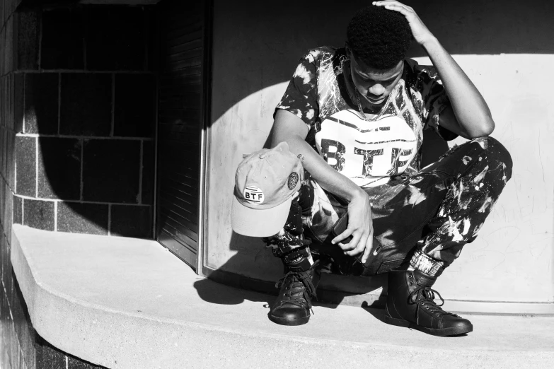 man with skateboard sitting on concrete steps in the sun