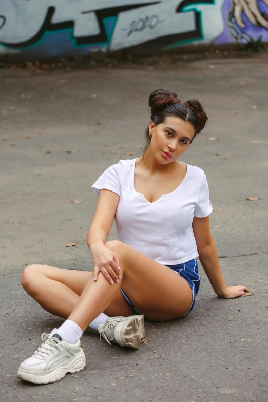 a woman sitting on the ground with her foot in the air