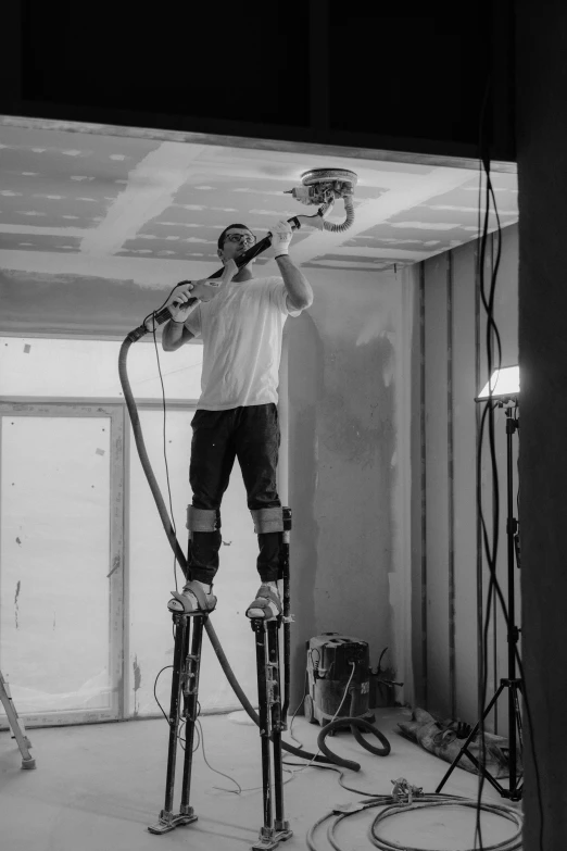 man standing on two skis in an unfinished room
