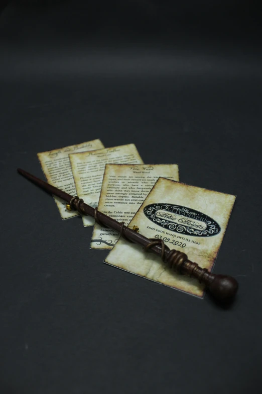 four harry potter scrolls, with a wooden staff