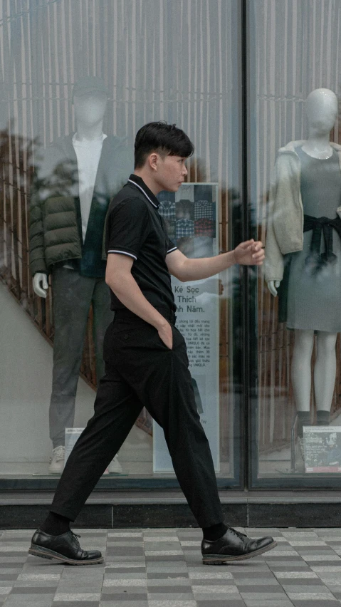 a man walking in front of a store window