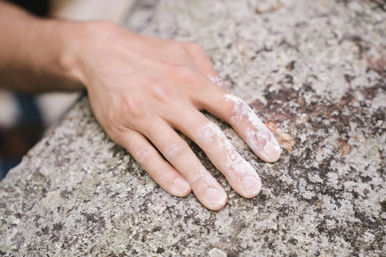 a hand with some white powder on it