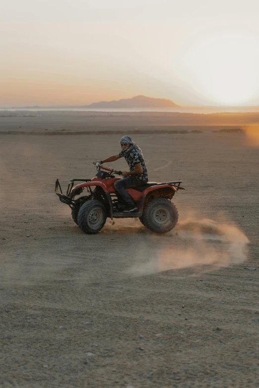 a person riding an atv in the desert