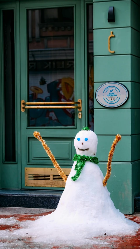 a snow man made of foam sits in front of a door