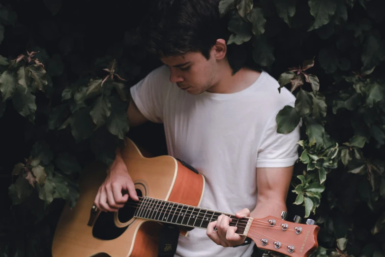 a guy with an acoustic guitar in his hand