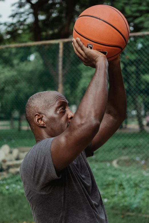 a man is holding a basketball in his right hand