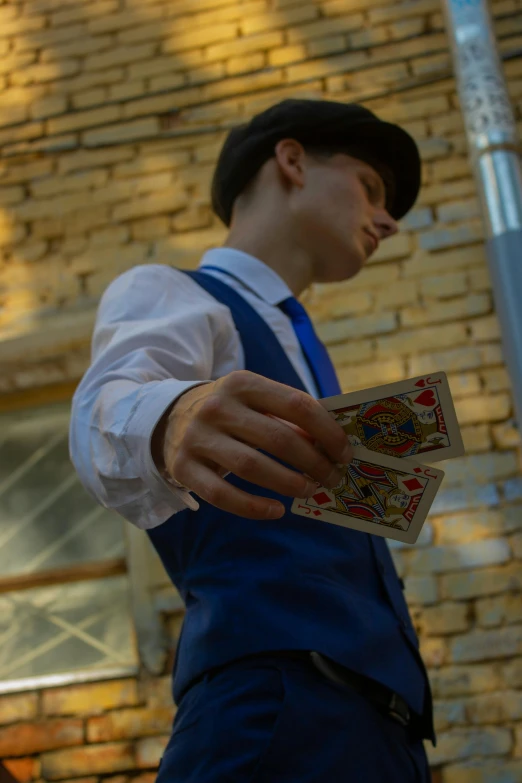 a man holding a deck of playing cards