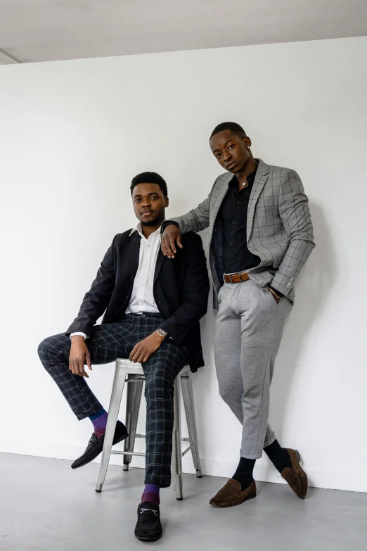 two men wearing suits sitting next to each other