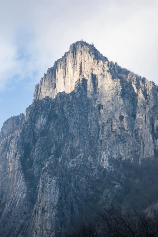 a large mountain with a very tall rock face