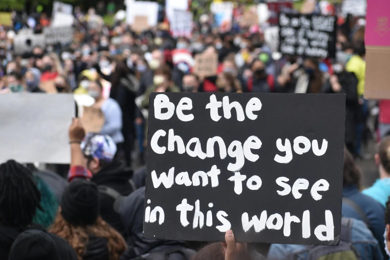 many people holding signs and protesting against climate change