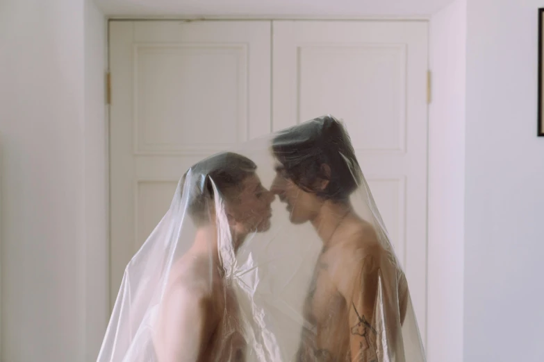 two people wearing veils are standing in a room