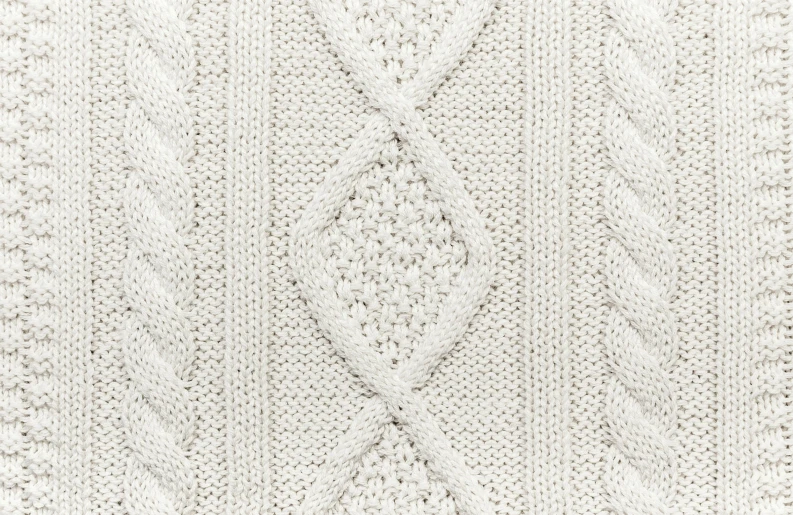 white knitted sweater with iding on front of it