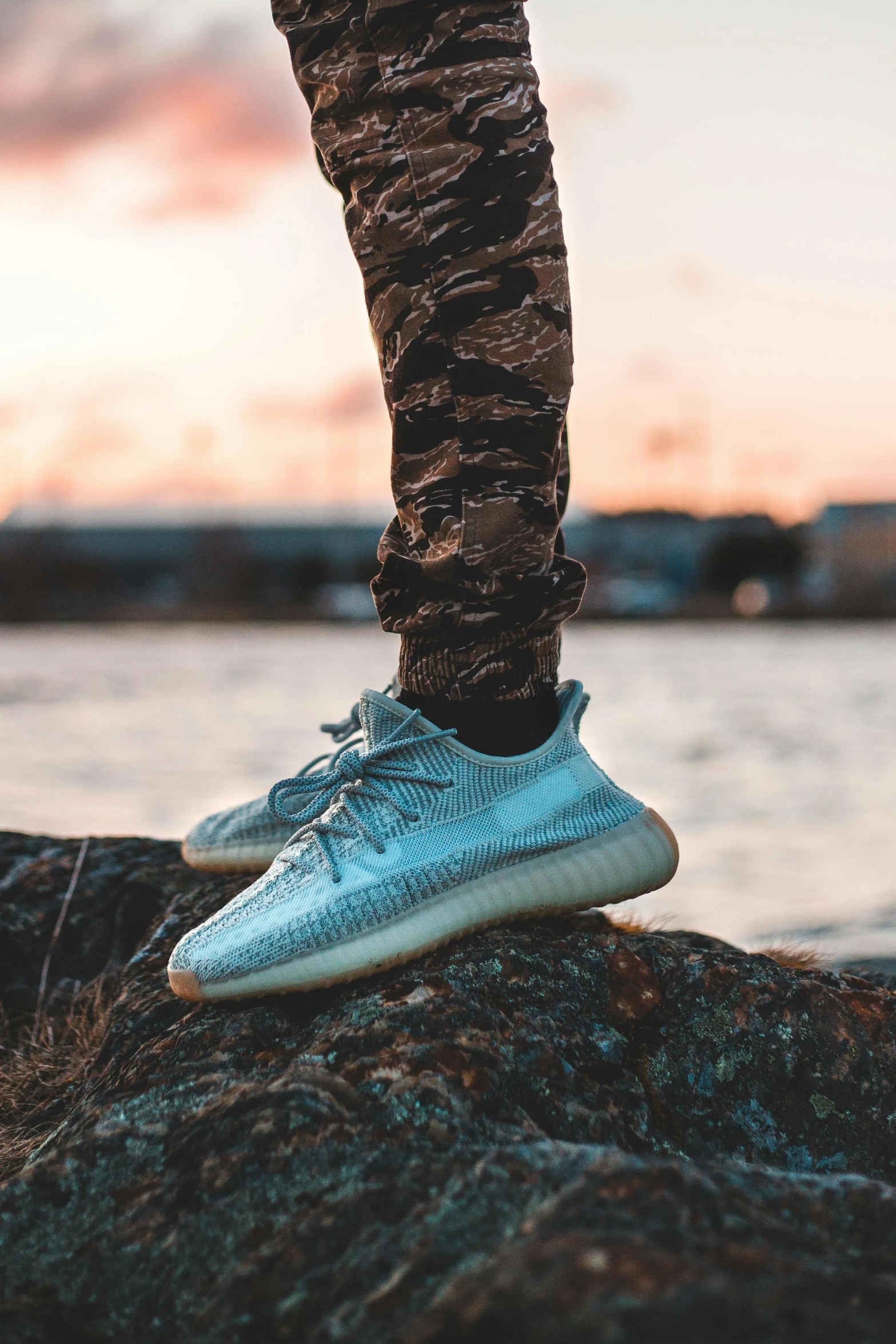 a person is standing on the edge of some water