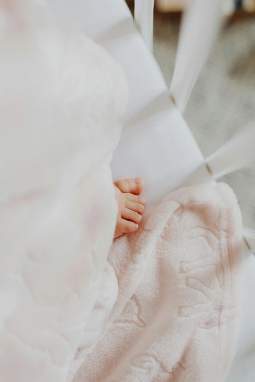 a close up of a person's hand on some wedding cloth