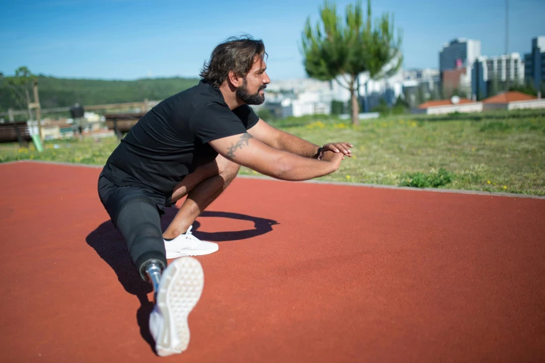 a man sits on the ground in a park