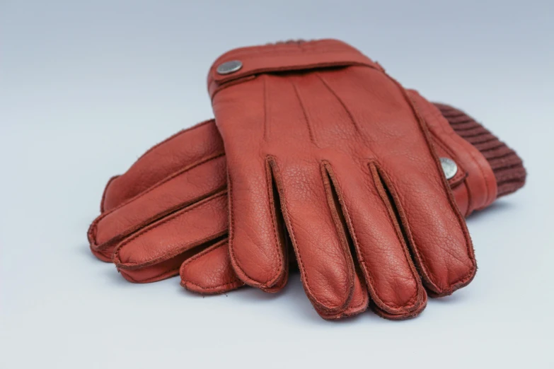 a red leather glove sitting on top of a table