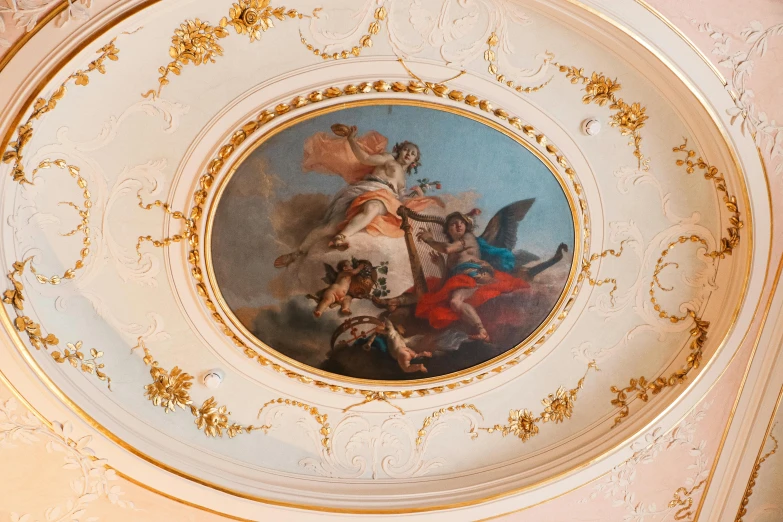 some paintings are hanging in the ceiling inside a house