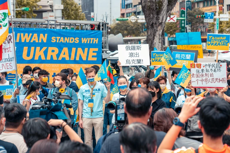 an image of people on a street with protest signs