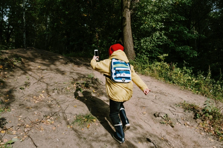 a young person walking along a dirt path