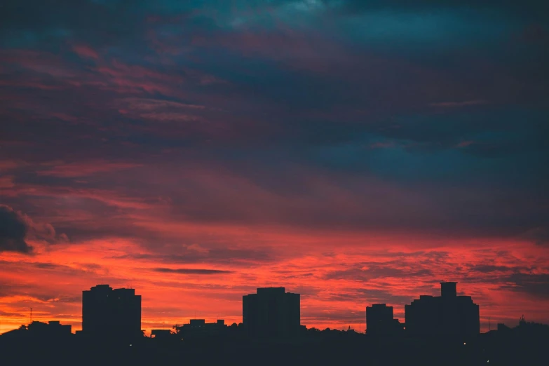 the city is full of tall buildings at sunset