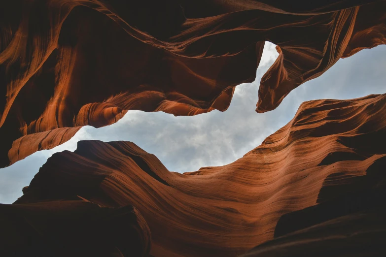 a rock formation with the sky above it