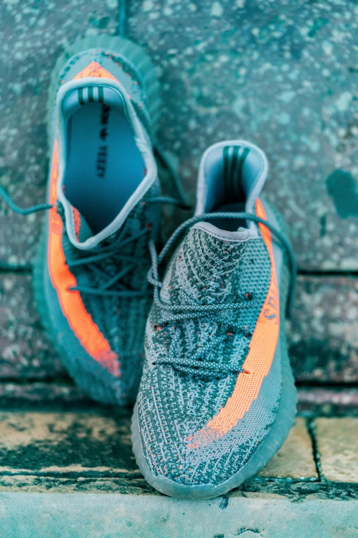 a pair of grey sneakers on the sidewalk