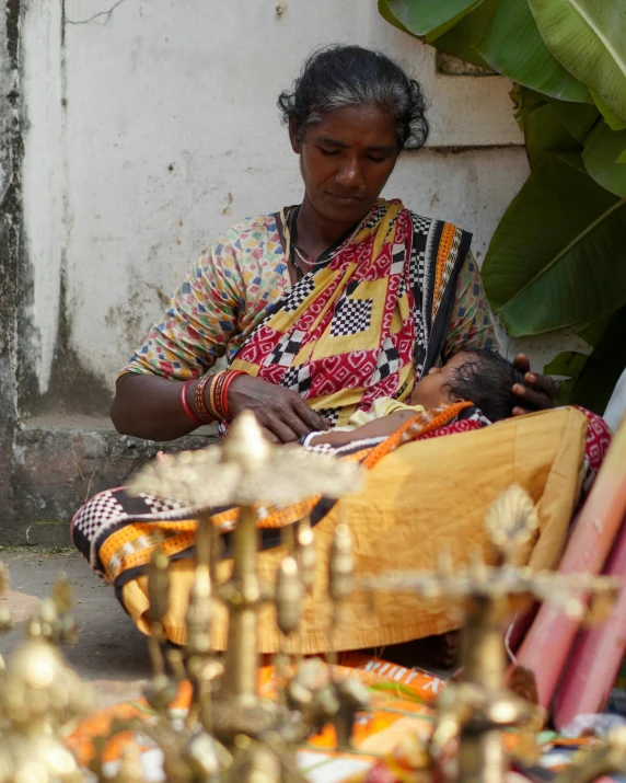 a woman sits next to a table with some items on it