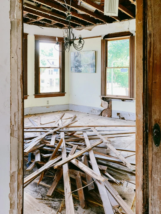 an empty room with a light and wooden beams